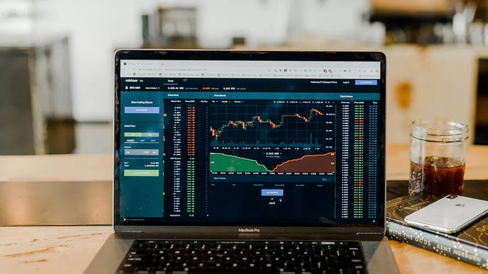 Photo of a laptop showing graphs