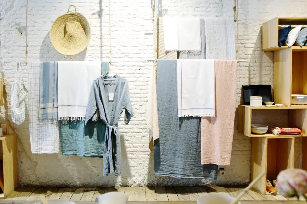 Clothes hanging on display in a store. Photo.