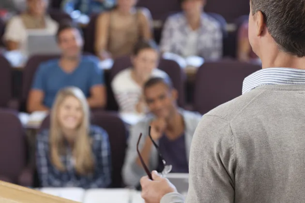 Photo of a person in front of an audience