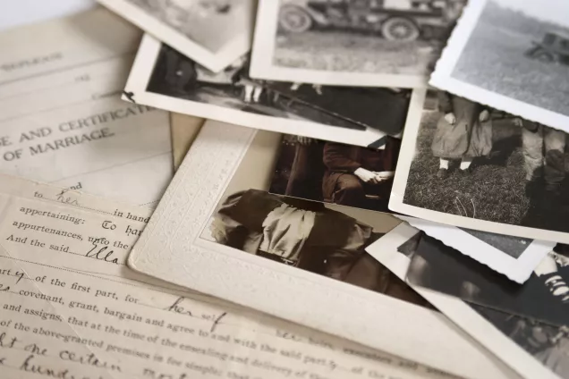 Old papers and photos in a pile. Photo.