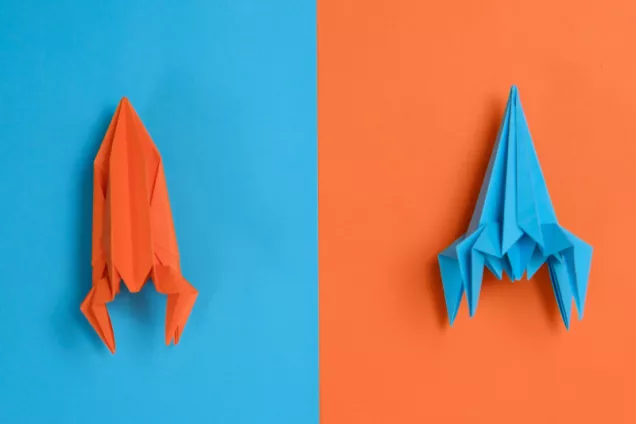 2 Coloured papers in origami shaped as rockets. Photo