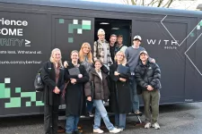 Photograph of 10 students standing in front of the CyberTruck.