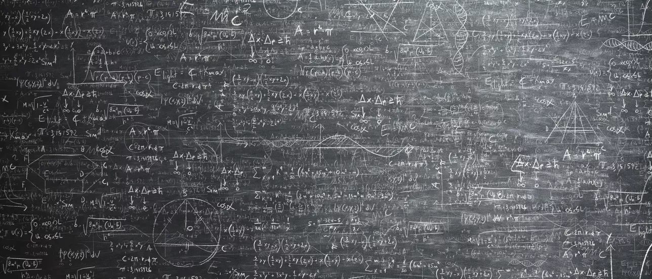 A lot of formulas and graphs on a blackboard