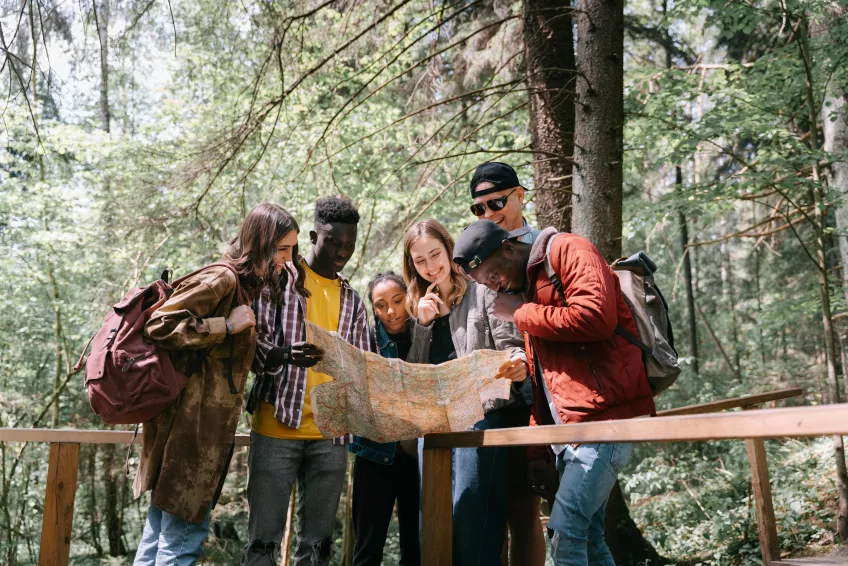 Students looking at map in the forest